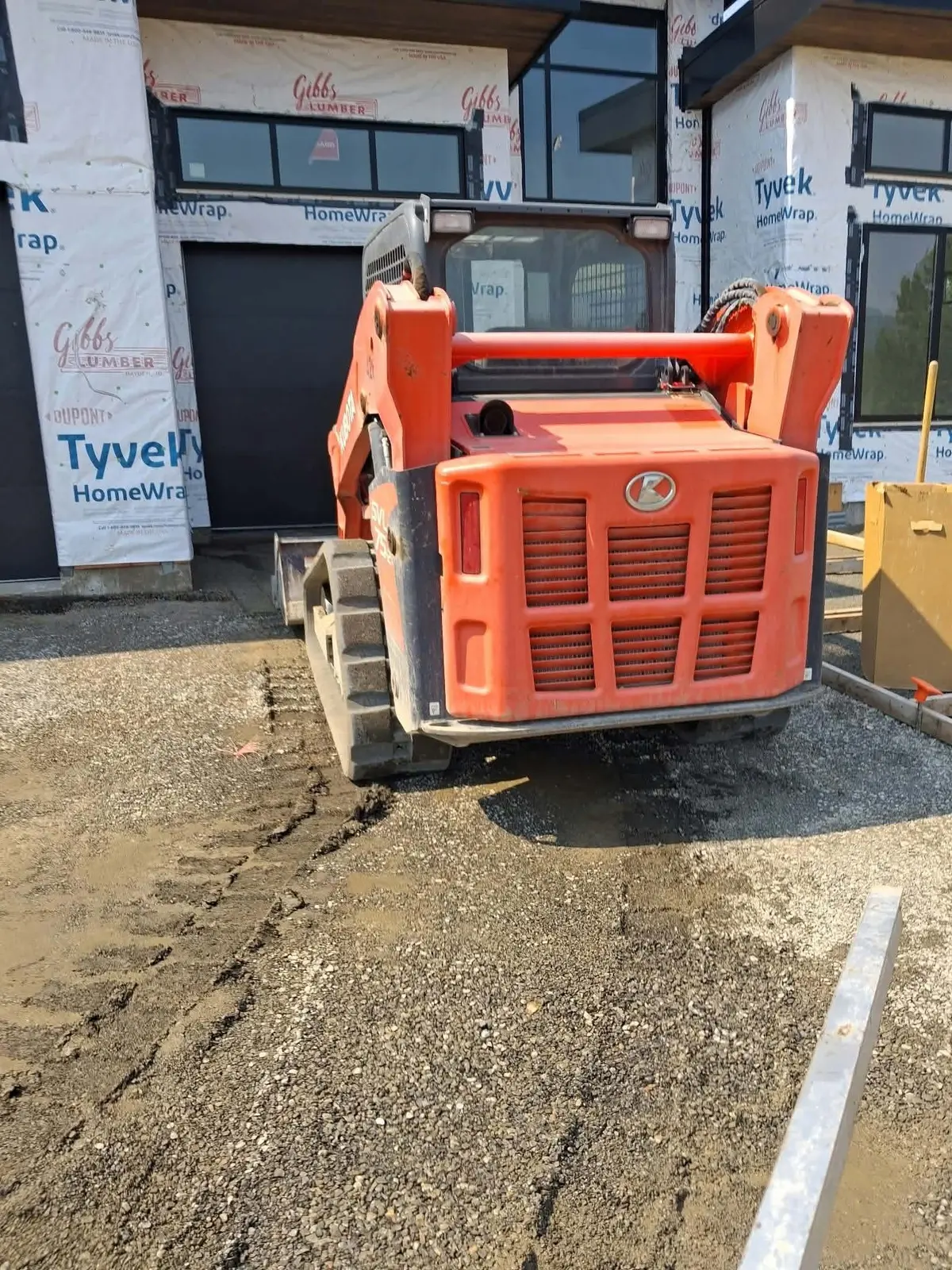Skid steer grading a new construction site